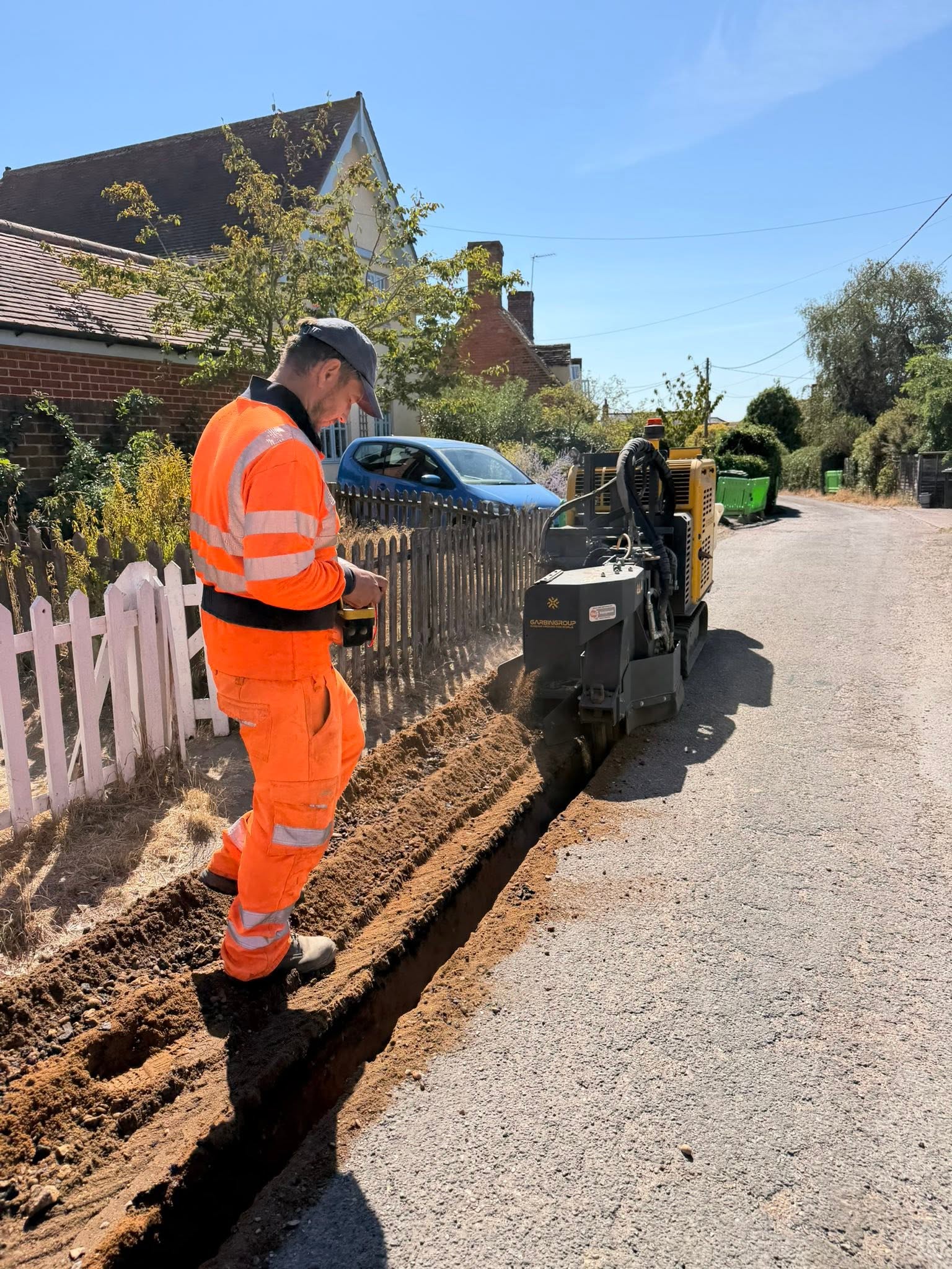 Wheel saw trenching beside a residential road